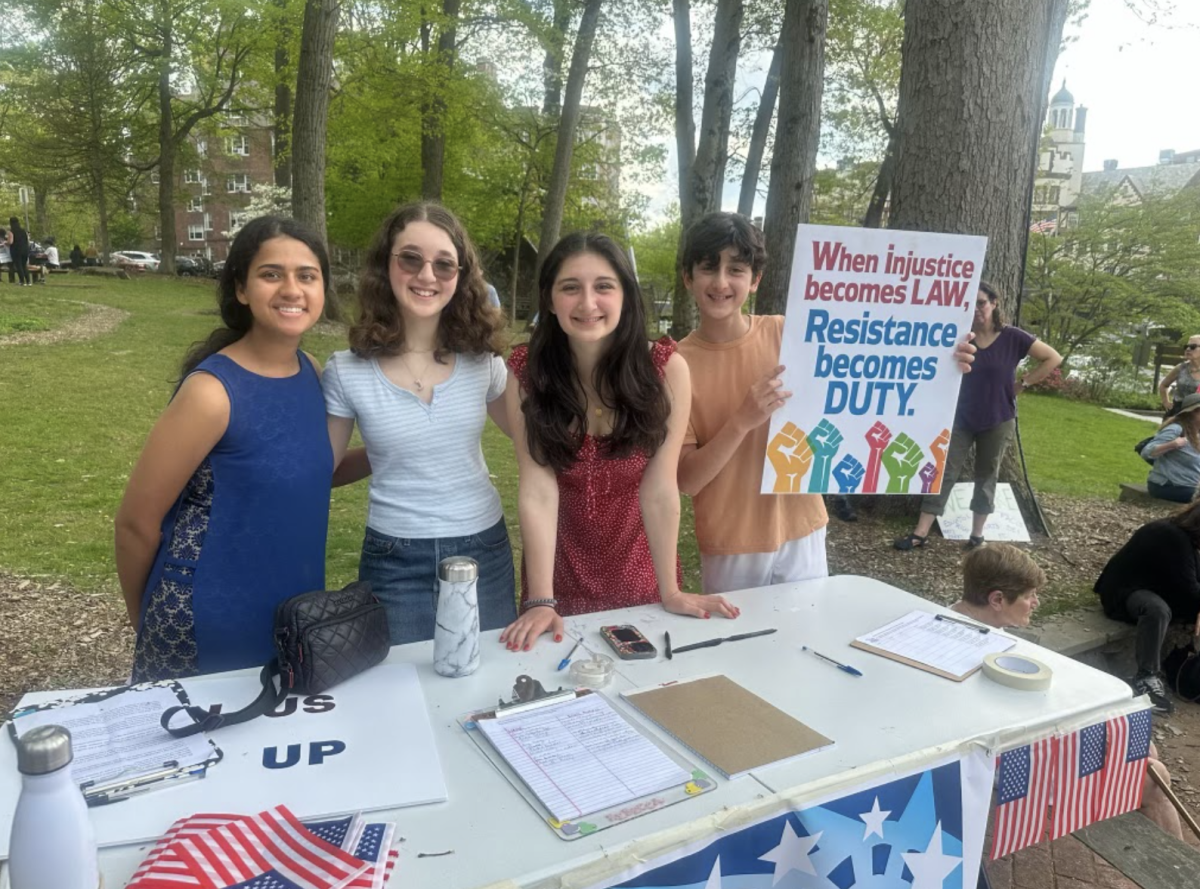 Scarsdale Students holding up a poster in support of the Democratic Rally.